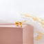 a close up of a gold ring on a white surface