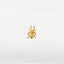 a gold spider ring sitting on top of a white sheet