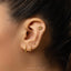 a close up of a person wearing a pair of ear piercings