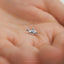 a tiny silver horse charm on a person&#39;s palm