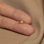 a person&#39;s hand with a gold ring on it