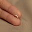 a person&#39;s finger with a gold ring on it