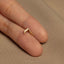 a person&#39;s finger with a gold ring on it