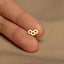 a person&#39;s finger with a tiny gold ring on it