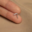 a person&#39;s finger with a small silver ring on it