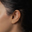 a close up of a person with a piercing in their ear