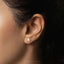 a close up of a person wearing a pair of ear piercings