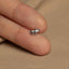 a tiny silver horse ring on someone&#39;s finger