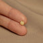 a person&#39;s finger with a tiny gold star ring on it