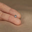 a person&#39;s left hand with a tiny ring on it