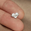 a small heart shaped pin with the word mama on it