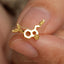 a close up of a person holding a gold ring